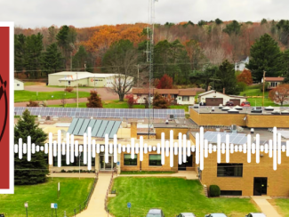 Watt's Up Wisconsin Logo with a photo of Bayfield County's municipal building with solar on the roof.